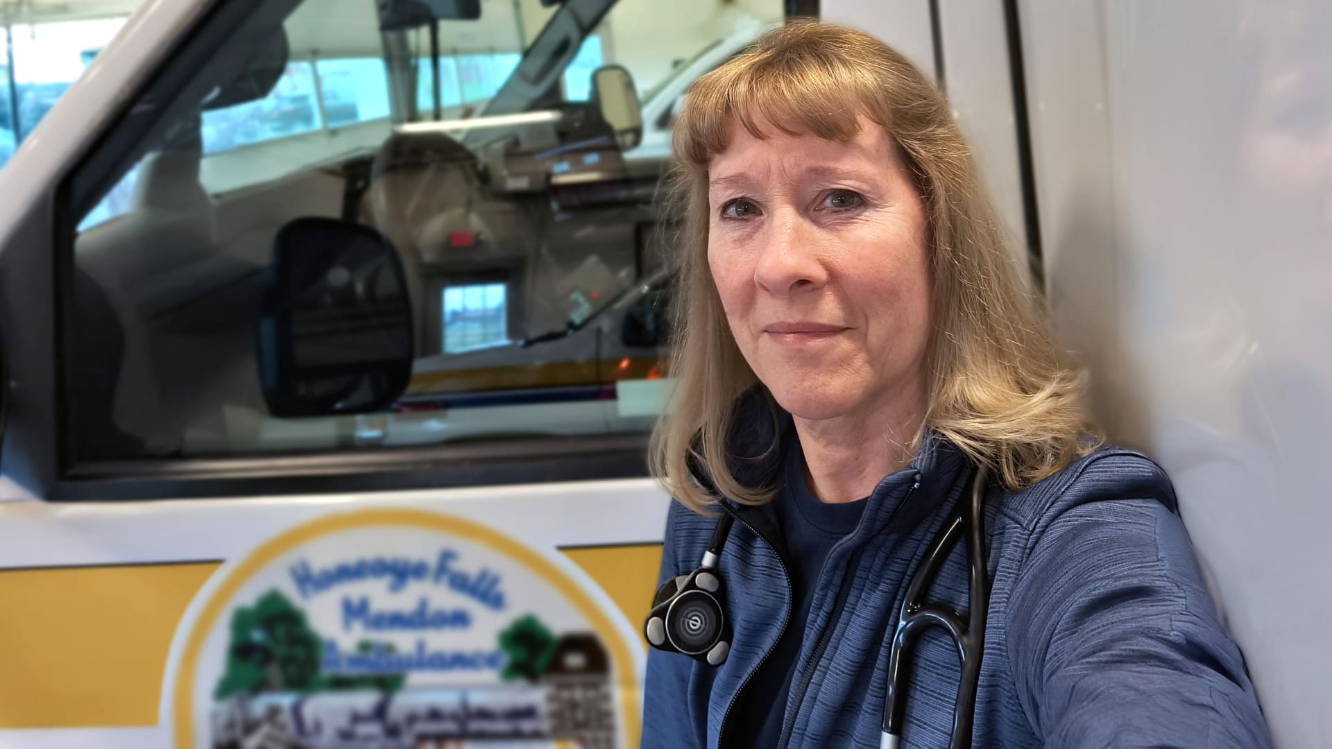 Paramedic poses outside her ambulance