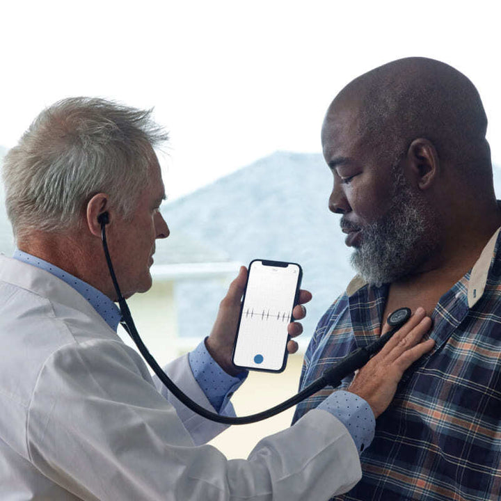 Clinician listening to the heart using an Eko DUO2